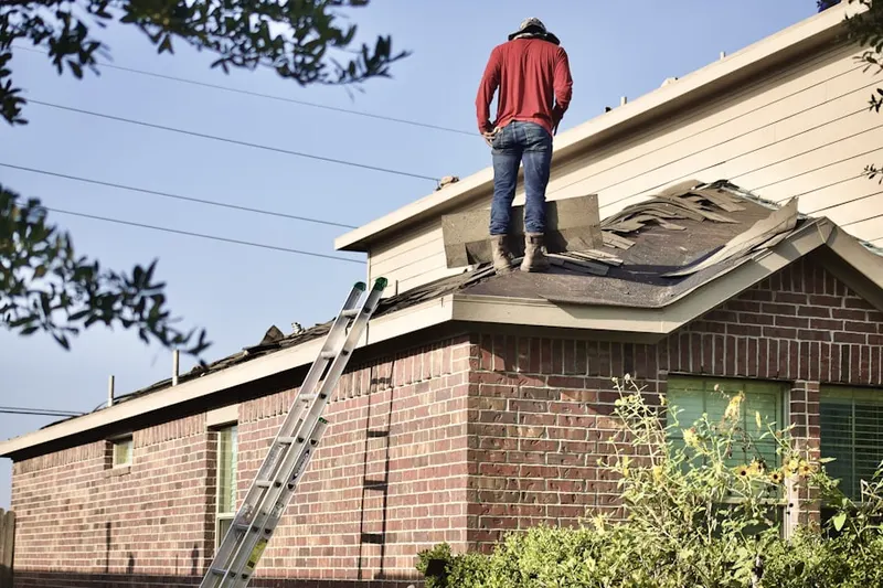 Professional roofer working on a residential roof in Cranford Junction